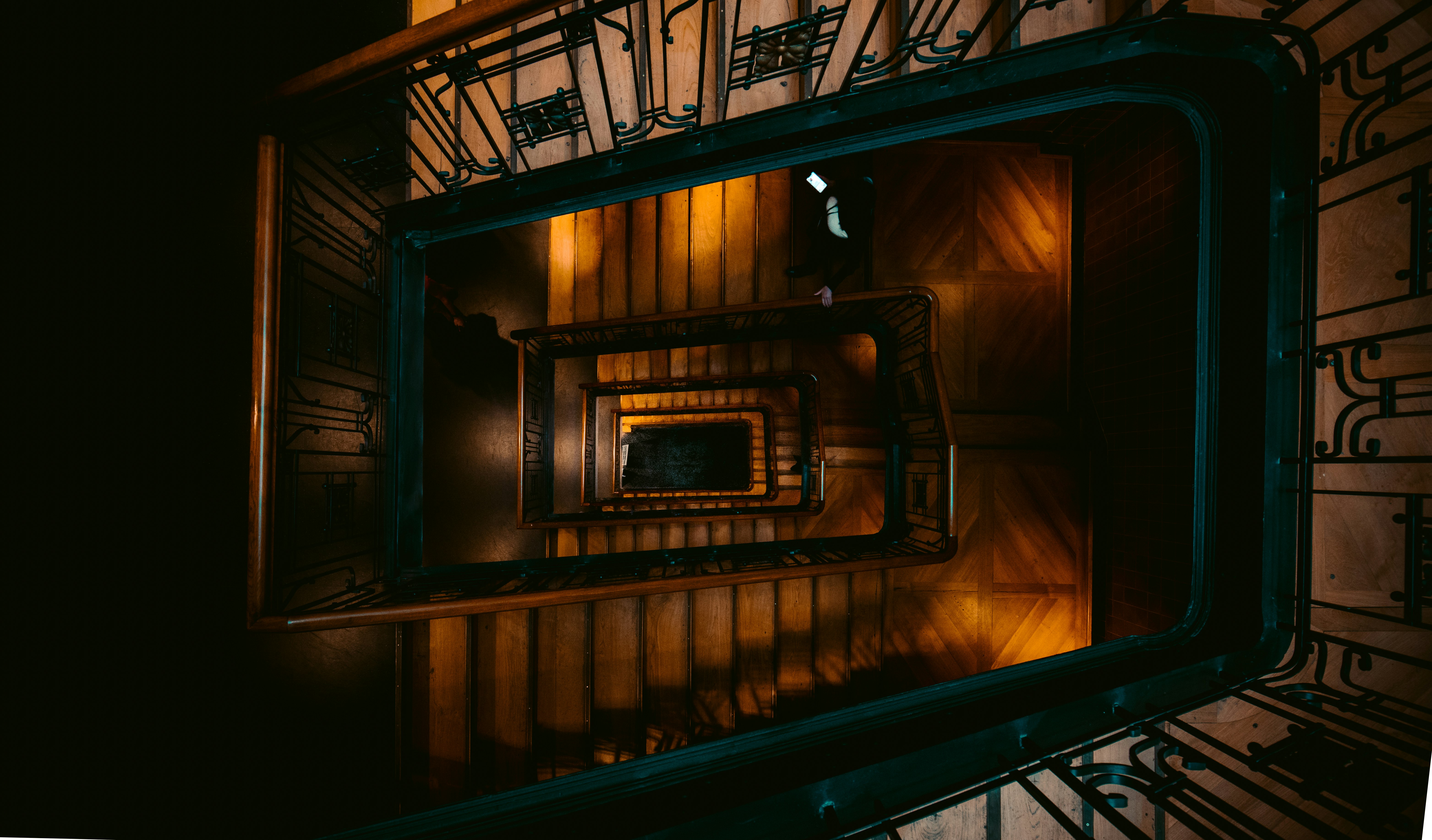 aerial photography of brown and green spiral stairs